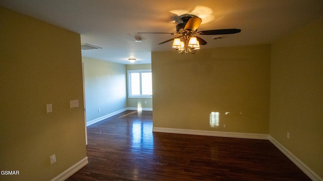 spare room with ceiling fan and dark wood-type flooring