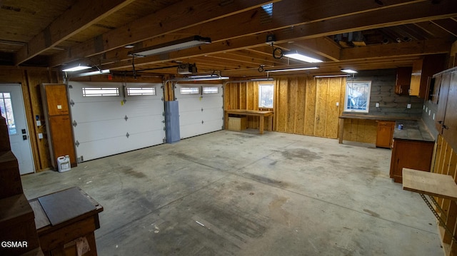 garage featuring a garage door opener and wood walls