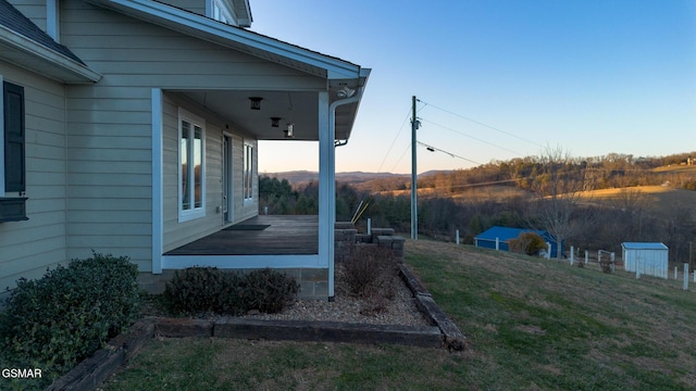 yard at dusk with a wooden deck