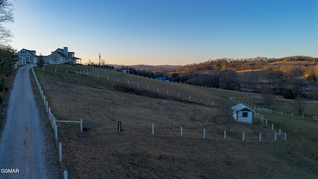 yard at dusk with a rural view