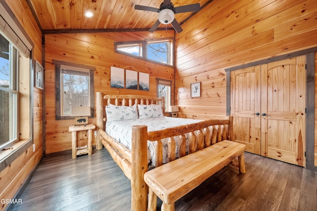 bedroom with lofted ceiling, wooden ceiling, dark hardwood / wood-style flooring, and wood walls