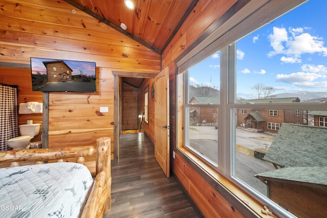 bedroom with wood ceiling, vaulted ceiling, and wood walls