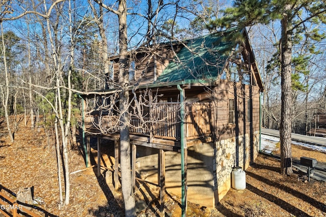 view of property exterior featuring a wooden deck