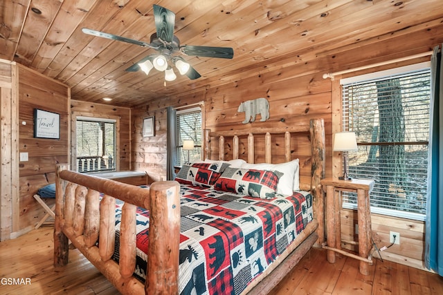 bedroom featuring multiple windows, hardwood / wood-style floors, ceiling fan, and wood ceiling