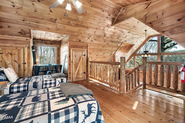 bedroom featuring wood walls, multiple windows, light wood-type flooring, and wood ceiling