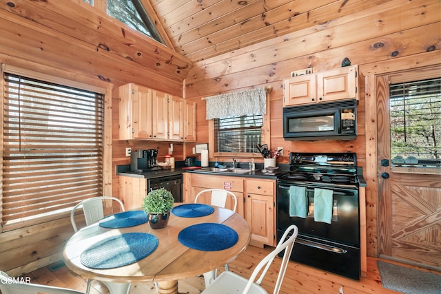 kitchen with black appliances, wood walls, sink, and light brown cabinets