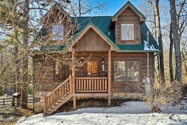 log home featuring a porch