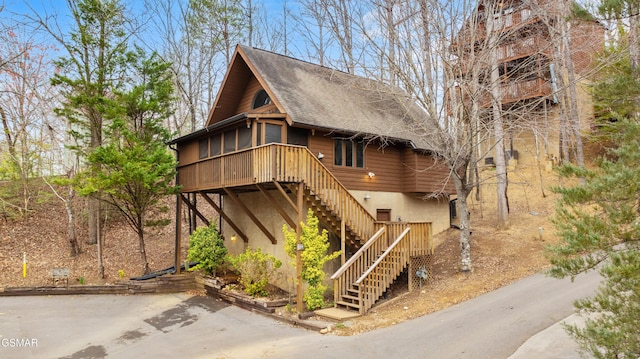 334 Greenwood Way, Pigeon Forge, TN 37863 - view of front facade featuring stairway, a shingled roof, and a sunroom