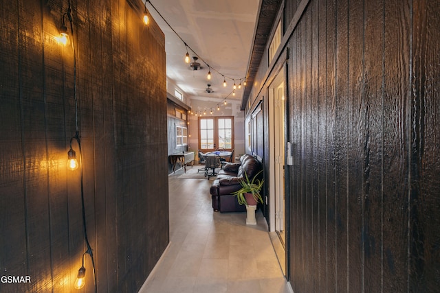 corridor featuring wooden walls