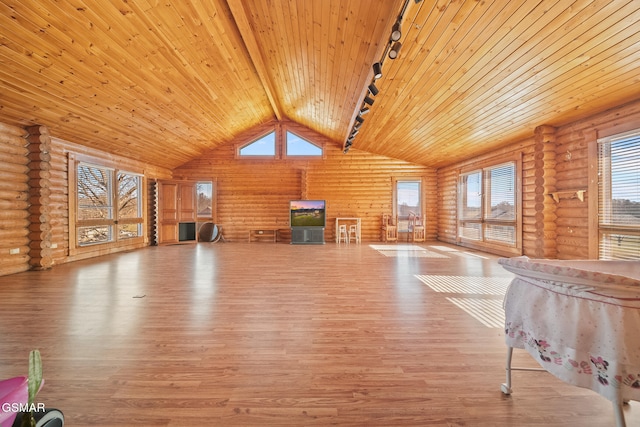 unfurnished living room with rustic walls, lofted ceiling with beams, wooden ceiling, wood finished floors, and rail lighting