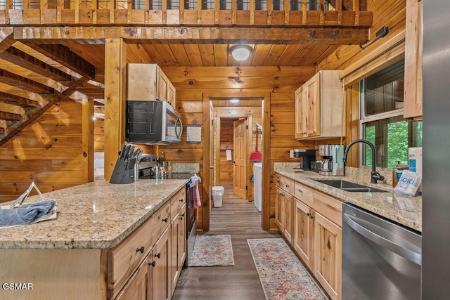 4372 Boogertown Rd Unit 1, Sevierville, TN 37876 - kitchen with stainless steel appliances, a sink, wooden walls, dark wood-style flooring, and light stone counters