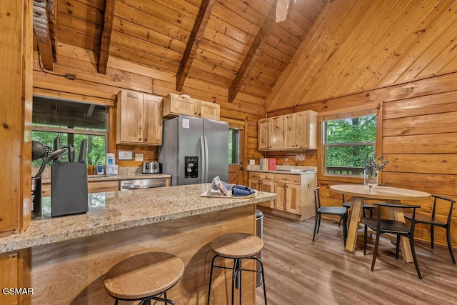 4372 Boogertown Rd Unit 1, Sevierville, TN 37876 - kitchen featuring stainless steel appliances, wood walls, healthy amount of natural light, wood finished floors, and wooden ceiling with exposed beams