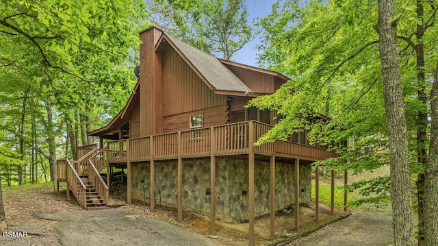 4372 Boogertown Rd Unit 1, Sevierville, TN 37876 - view of side of home with stairs, a wooden deck, a shingled roof, and stone siding