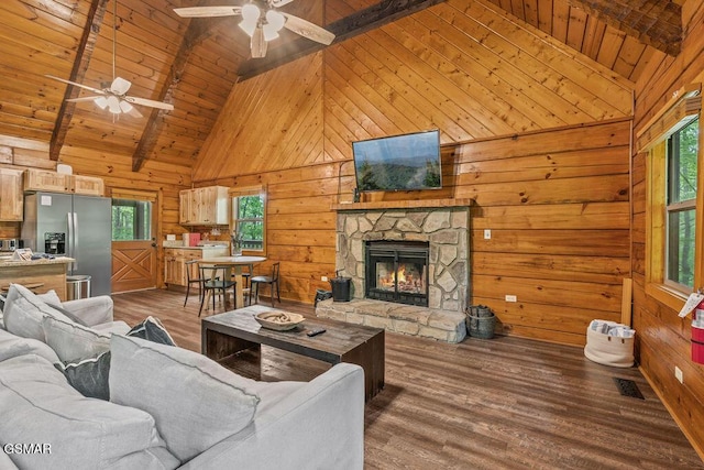 4372 Boogertown Rd Unit 1, Sevierville, TN 37876 - living area with a ceiling fan, wooden ceiling with exposed beams, wooden walls, wood finished floors, and a fireplace