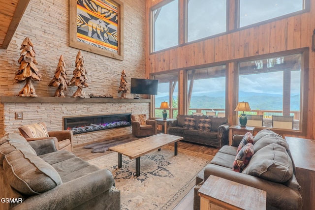 2414 Hackberry Dr, Sevierville, TN 37862 - living area featuring a towering ceiling, wood finished floors, wooden walls, and a fireplace