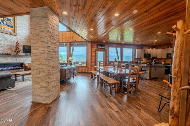 2414 Hackberry Dr, Sevierville, TN 37862 - dining room featuring wooden ceiling, dark wood-type flooring, a stone fireplace, recessed lighting, and lofted ceiling