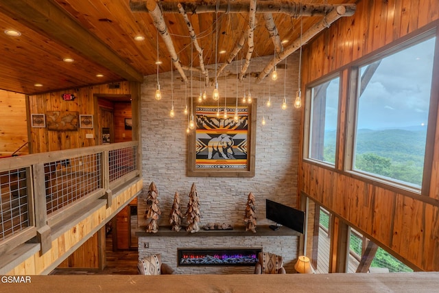 2414 Hackberry Dr, Sevierville, TN 37862 - dining area with wood walls, a wooden ceiling with exposed beams, a fireplace, and recessed lighting