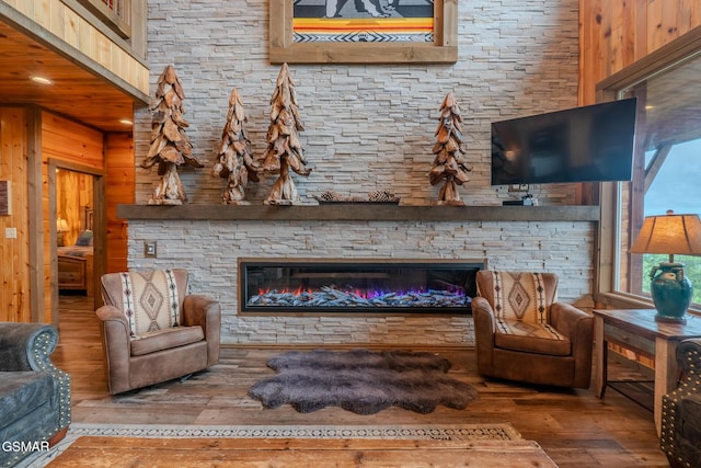 2414 Hackberry Dr, Sevierville, TN 37862 - living room with hardwood / wood-style floors, a fireplace, wooden walls, and recessed lighting