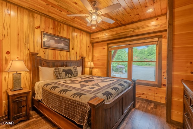 2414 Hackberry Dr, Sevierville, TN 37862 - bedroom with wooden walls, dark wood-style flooring, wooden ceiling, and ceiling fan