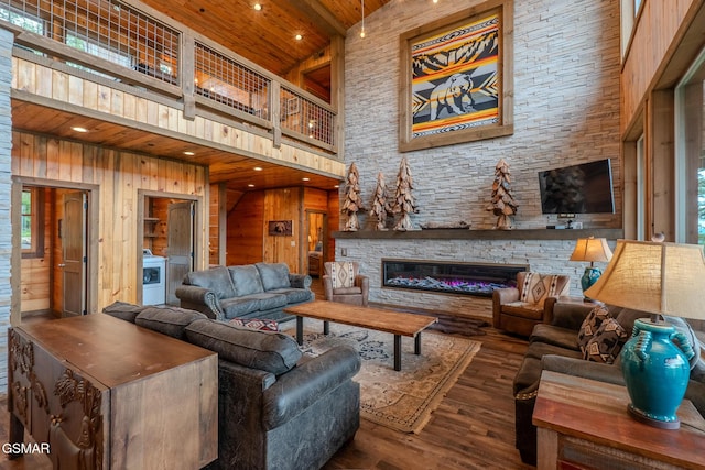 2414 Hackberry Dr, Sevierville, TN 37862 - living room featuring a high ceiling, wood finished floors, wood ceiling, washer / dryer, and wooden walls