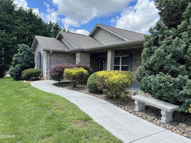 1018 Southwind Cir, Dandridge, TN 37725 - view of front facade with a front lawn, a shingled roof, and brick siding