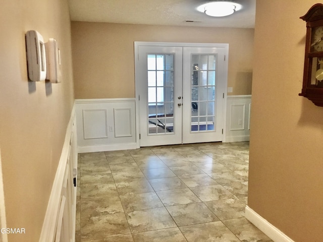 1018 Southwind Cir, Dandridge, TN 37725 - doorway to outside with french doors, wainscoting, and a decorative wall