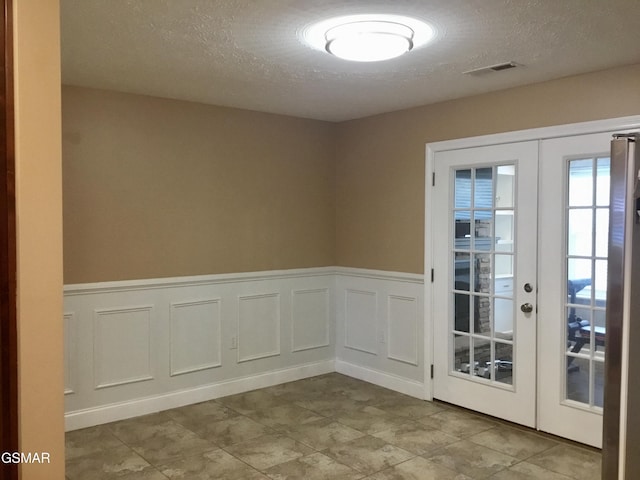 1018 Southwind Cir, Dandridge, TN 37725 - empty room featuring french doors, a textured ceiling, and a wainscoted wall