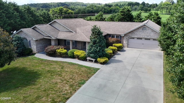 1018 Southwind Cir, Dandridge, TN 37725 - view of front of home with a garage, driveway, a front yard, brick siding, and stone siding
