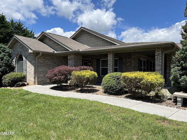 1018 Southwind Cir, Dandridge, TN 37725 - view of front of house featuring a front yard, brick siding, and a shingled roof