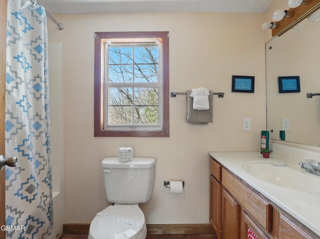 full bath featuring baseboards, toilet, and vanity