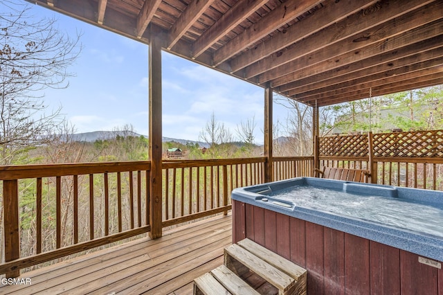 wooden terrace with a hot tub