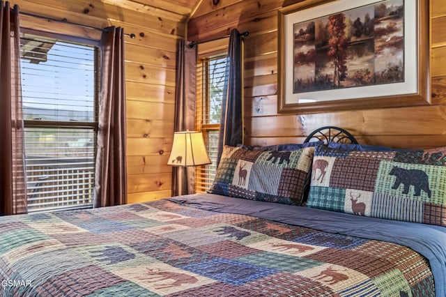 bedroom with wood walls and lofted ceiling