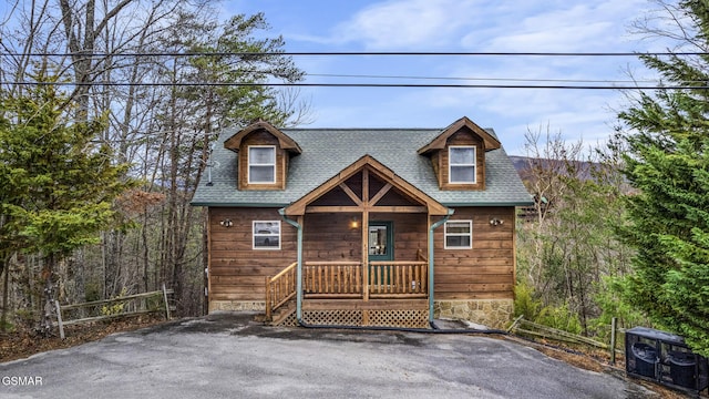 rustic home with a shingled roof