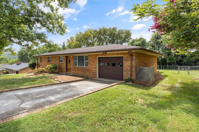 single story home featuring a garage and a front lawn