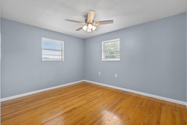 spare room with ceiling fan and light hardwood / wood-style flooring