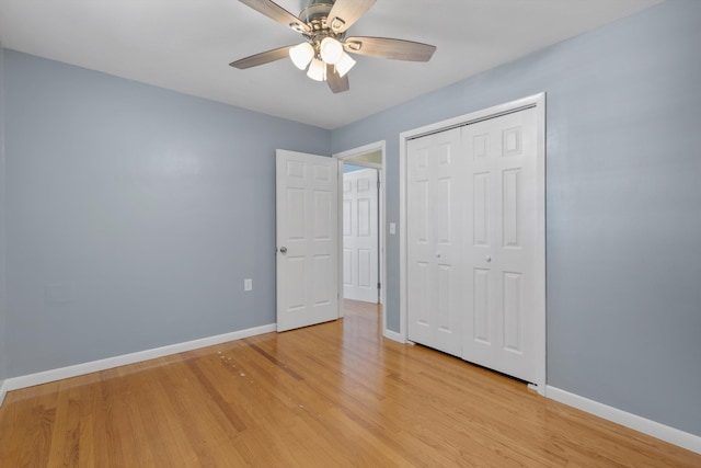 unfurnished bedroom featuring ceiling fan, light hardwood / wood-style floors, and a closet