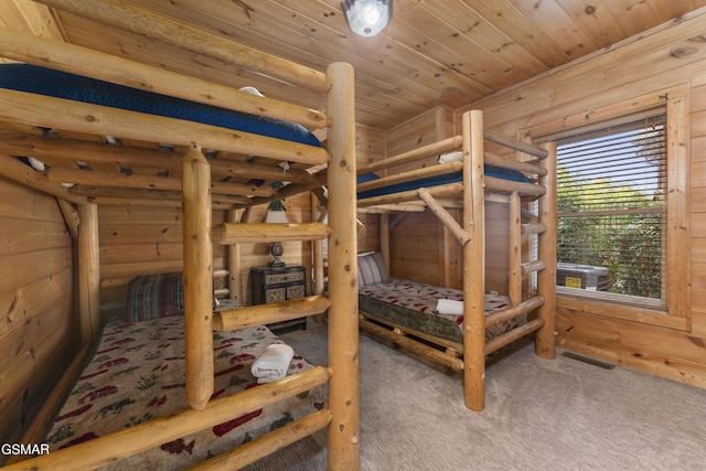 carpeted bedroom with log walls, wooden ceiling, and wood walls