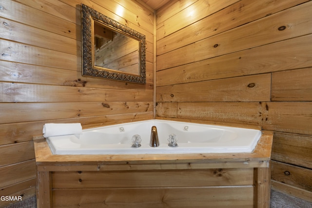 bathroom with a bathing tub and wood walls