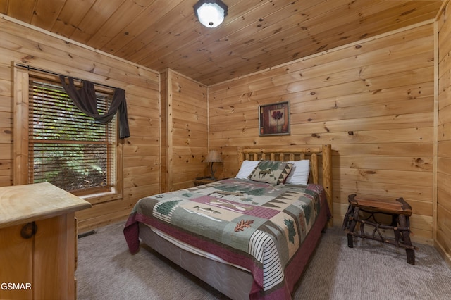 bedroom featuring carpet, wood ceiling, and wooden walls