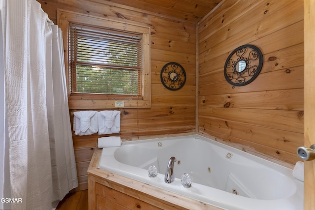 bathroom featuring wooden walls and a washtub