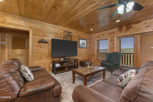 living room with wood walls, ceiling fan, and wooden ceiling