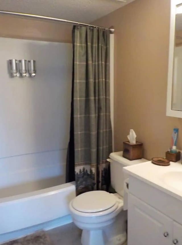 full bathroom featuring shower / bath combo, vanity, and toilet