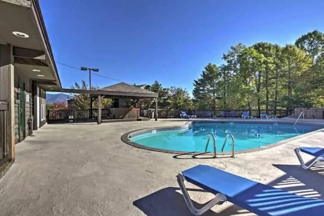 view of swimming pool with a gazebo and a patio area