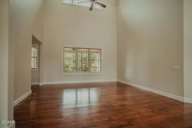 118 Luxury Ln, Dandridge, TN 37725 - unfurnished living room featuring a ceiling fan, a high ceiling, baseboards, and wood finished floors