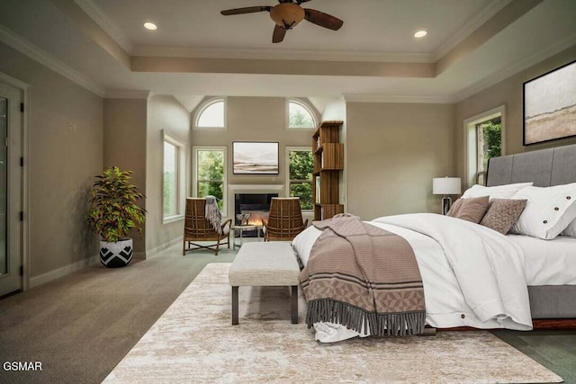 118 Luxury Ln, Dandridge, TN 37725 - carpeted bedroom with a raised ceiling, multiple windows, a lit fireplace, recessed lighting, and ornamental molding