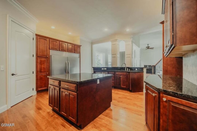 118 Luxury Ln, Dandridge, TN 37725 - kitchen featuring built in fridge, a center island, light wood finished floors, a ceiling fan, and crown molding