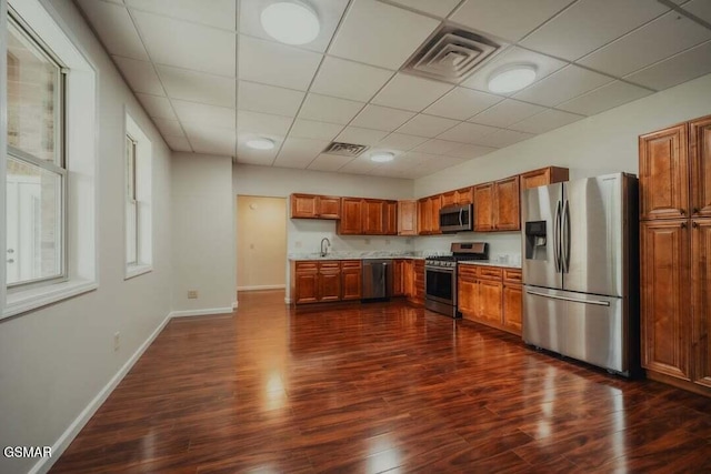 118 Luxury Ln, Dandridge, TN 37725 - kitchen with appliances with stainless steel finishes, a sink, light countertops, dark wood-style flooring, and brown cabinetry