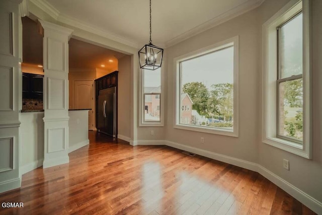 118 Luxury Ln, Dandridge, TN 37725 - unfurnished dining area with ornate columns, wood finished floors, ornamental molding, a chandelier, and baseboards