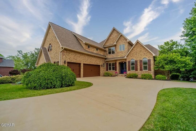 118 Luxury Ln, Dandridge, TN 37725 - craftsman inspired home featuring brick siding, a front lawn, and concrete driveway