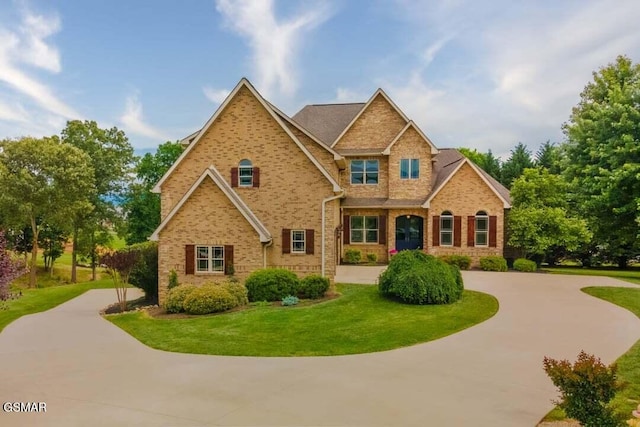 118 Luxury Ln, Dandridge, TN 37725 - view of front of home featuring brick siding and a front yard